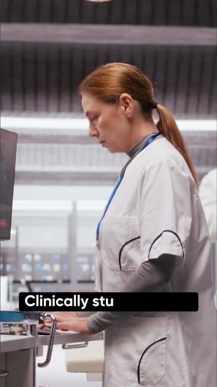 A laboratory professional at work in a doctor-led FemClarity creative.