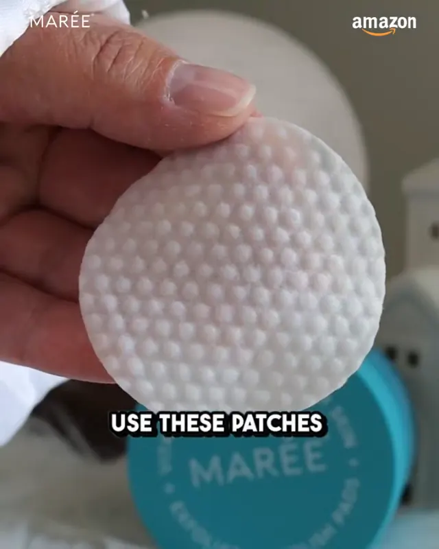 A hand holding a round foot-care patch in front of a MARÉE container.