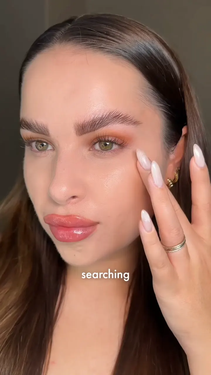 A close-up beauty demonstration showing a finished makeup look.